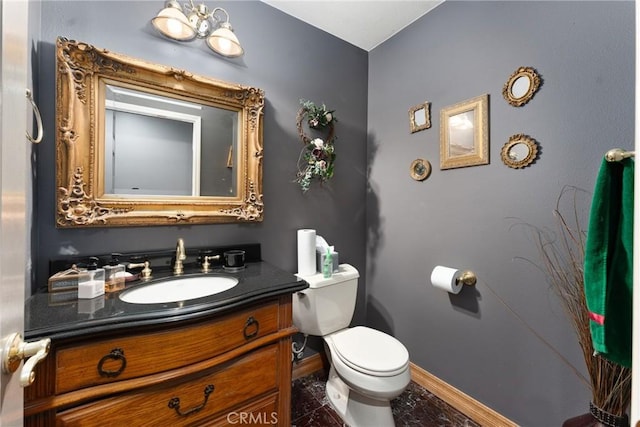 bathroom with tile patterned flooring, vanity, and toilet