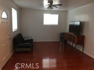 living area with ceiling fan and dark hardwood / wood-style floors