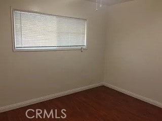 empty room featuring dark hardwood / wood-style flooring and ceiling fan