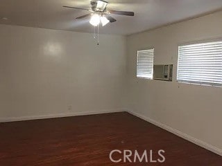 unfurnished room with dark hardwood / wood-style floors and ceiling fan