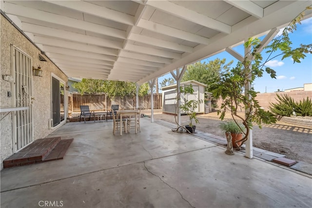 view of patio featuring a shed