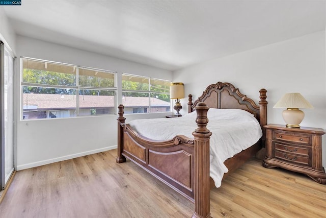 bedroom with light wood-type flooring and multiple windows