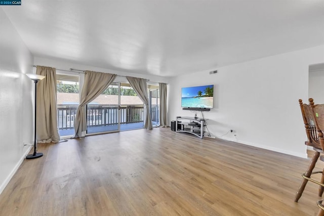 unfurnished living room with light hardwood / wood-style floors