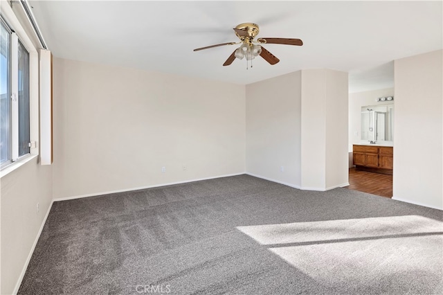 carpeted spare room featuring ceiling fan