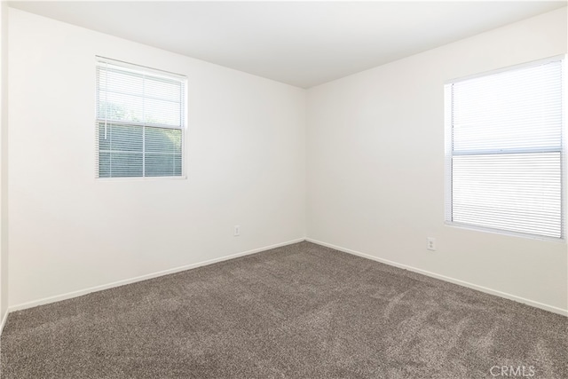 empty room with dark colored carpet