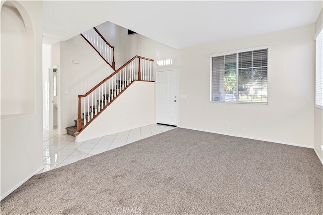 unfurnished living room featuring light colored carpet