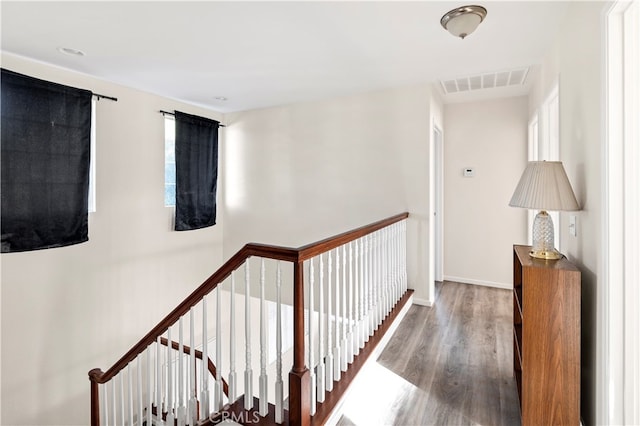 corridor with hardwood / wood-style flooring