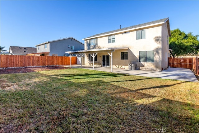 rear view of property featuring a yard and a patio