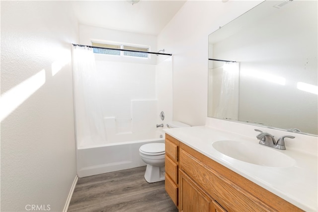 full bathroom with shower / bath combination with curtain, hardwood / wood-style floors, vanity, and toilet