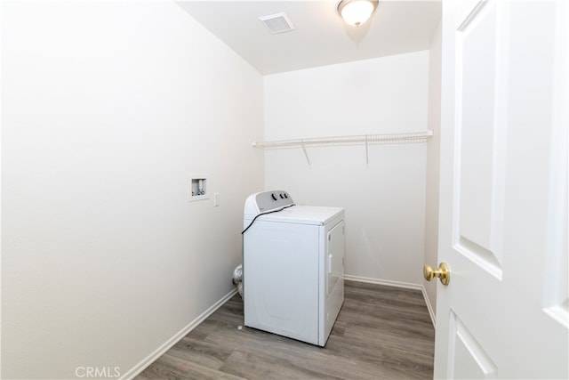 clothes washing area with washer / dryer and wood-type flooring