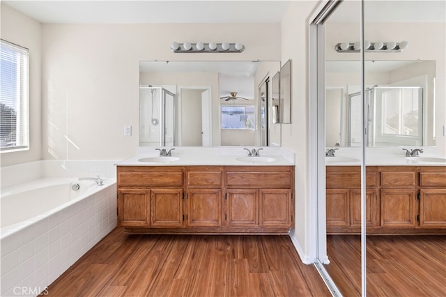 bathroom featuring independent shower and bath, vanity, and hardwood / wood-style flooring