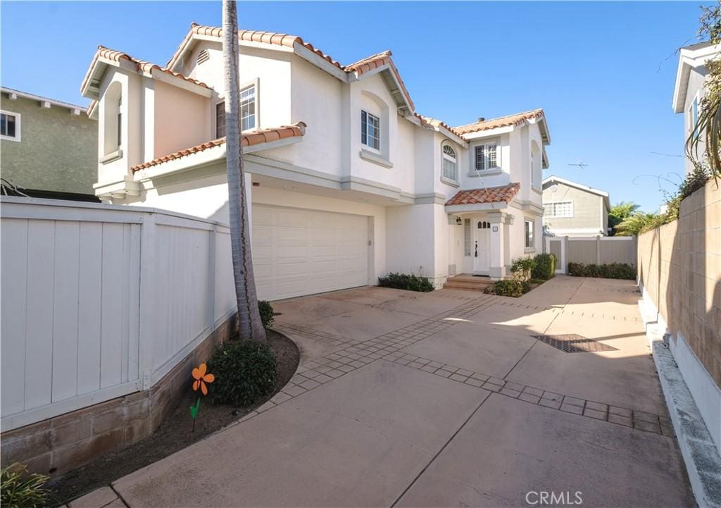 mediterranean / spanish-style house with a garage