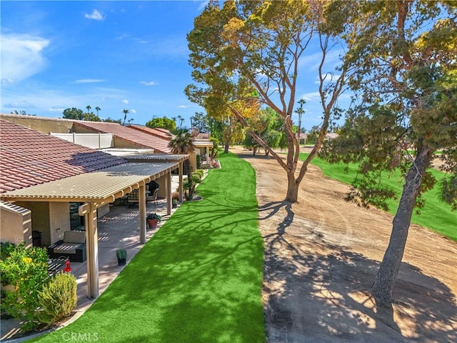 view of community with a lawn and a patio area