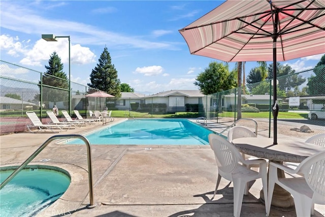 view of swimming pool with a patio area and a hot tub