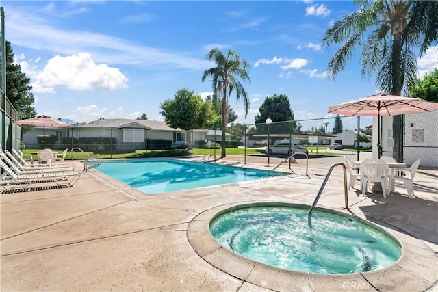 view of swimming pool with a community hot tub and a patio