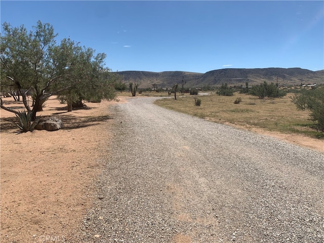 view of street with a mountain view and a rural view