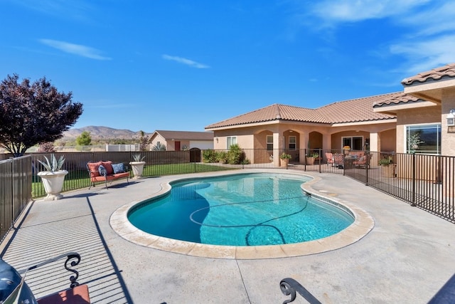 view of swimming pool with a mountain view and a patio