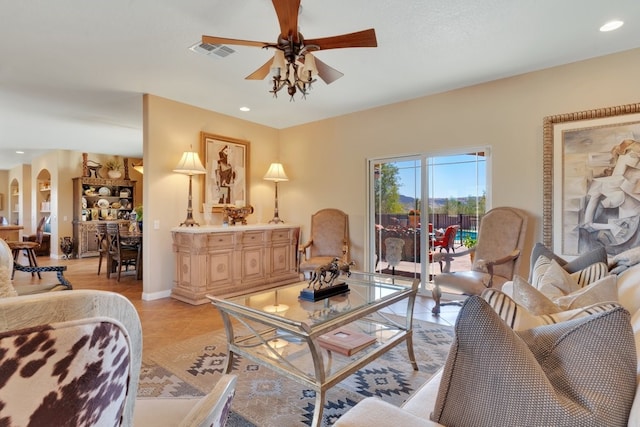 living room featuring light tile patterned flooring and ceiling fan