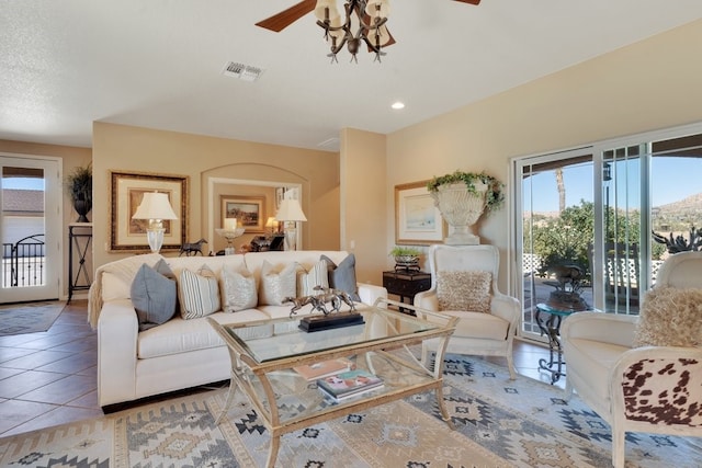 tiled living room with ceiling fan