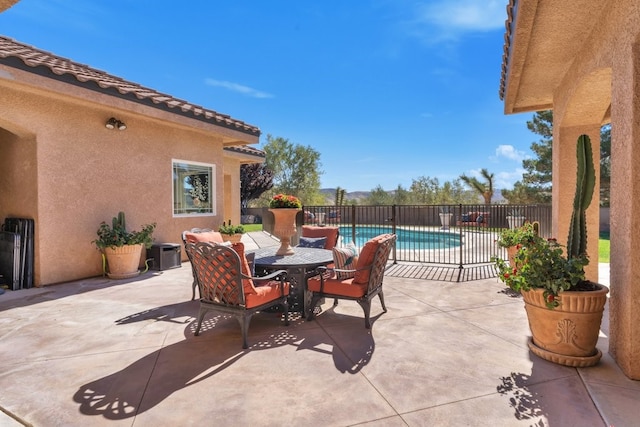 view of patio with a fenced in pool