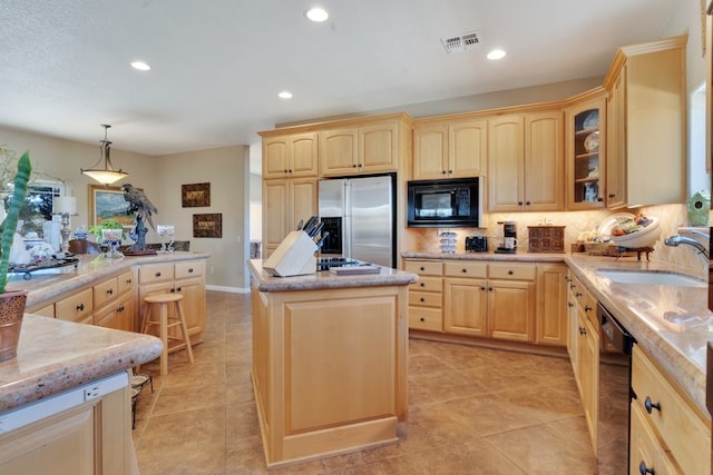 kitchen featuring light brown cabinetry, black appliances, a center island, and sink