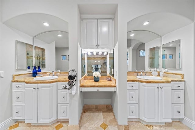 bathroom with walk in shower and vanity