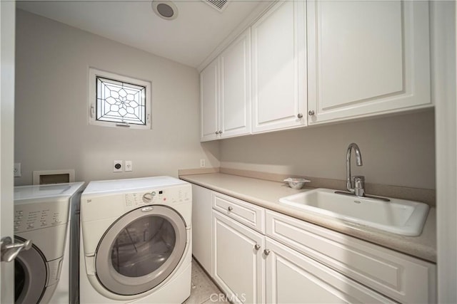 laundry room featuring washer and dryer, cabinets, light tile patterned floors, and sink