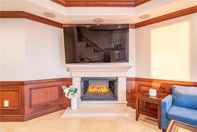 living area featuring a tray ceiling and crown molding