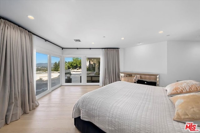 bedroom with light hardwood / wood-style flooring and access to exterior