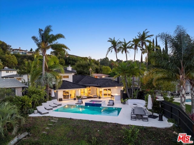 view of pool with an in ground hot tub and a patio area