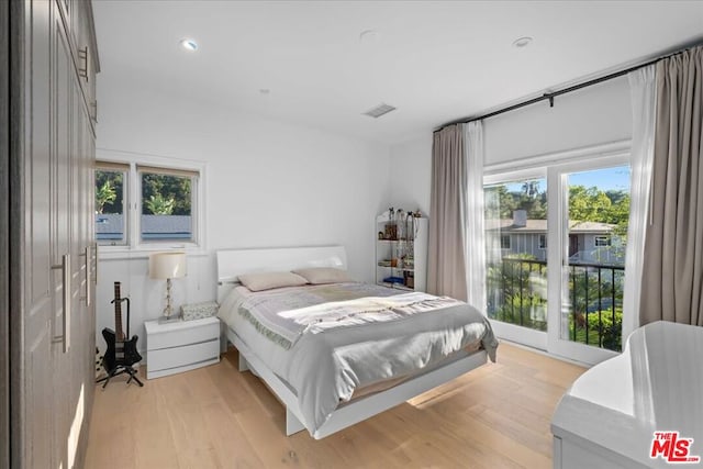 bedroom featuring light hardwood / wood-style floors and multiple windows