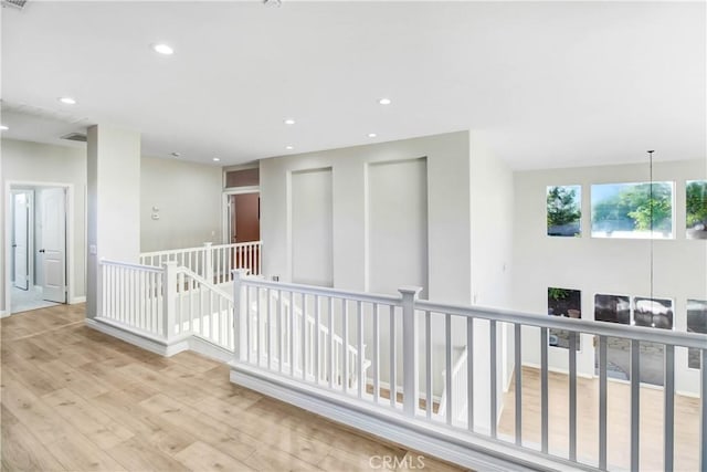 hallway featuring a chandelier and light wood-type flooring