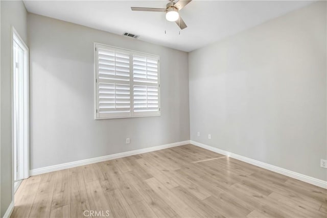 empty room featuring ceiling fan and light hardwood / wood-style flooring