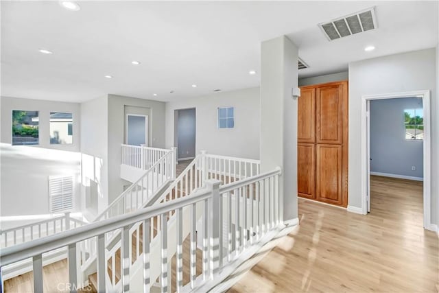 hallway with light hardwood / wood-style flooring