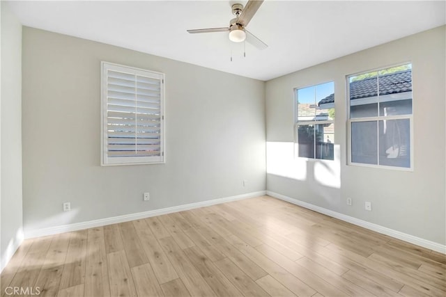 empty room featuring ceiling fan and light hardwood / wood-style flooring