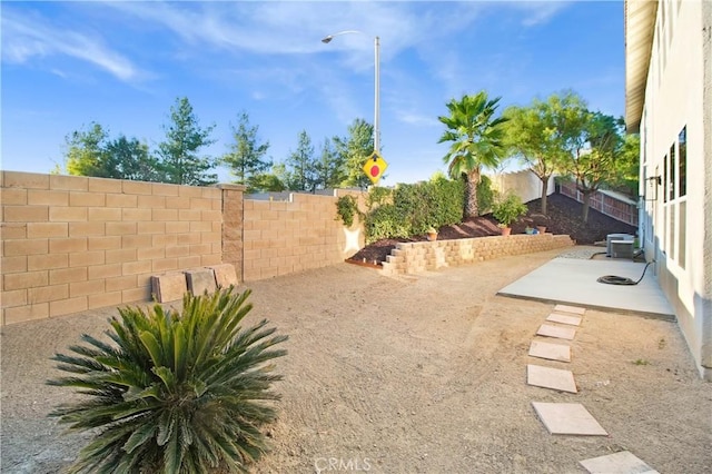 view of yard with a patio area and central AC unit