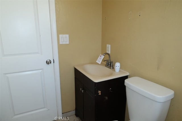 bathroom with toilet and vanity