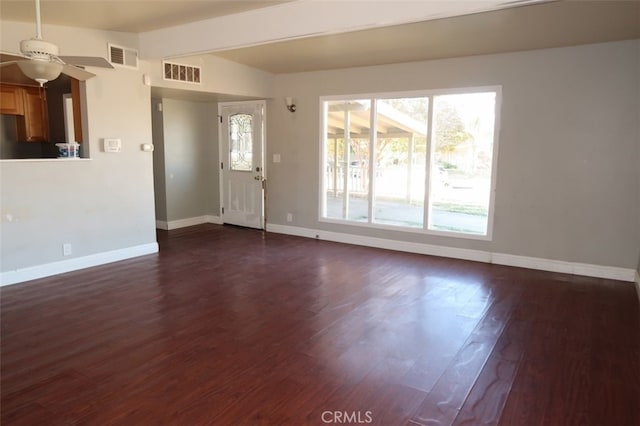 unfurnished living room with ceiling fan and dark hardwood / wood-style flooring