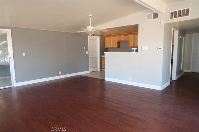 unfurnished living room featuring dark wood-type flooring, lofted ceiling with beams, and ceiling fan