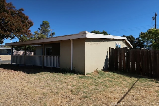 view of side of home with a lawn