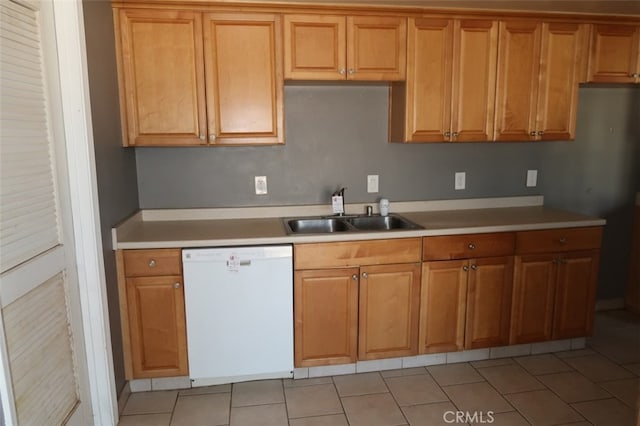 kitchen featuring white dishwasher, sink, and light tile patterned flooring