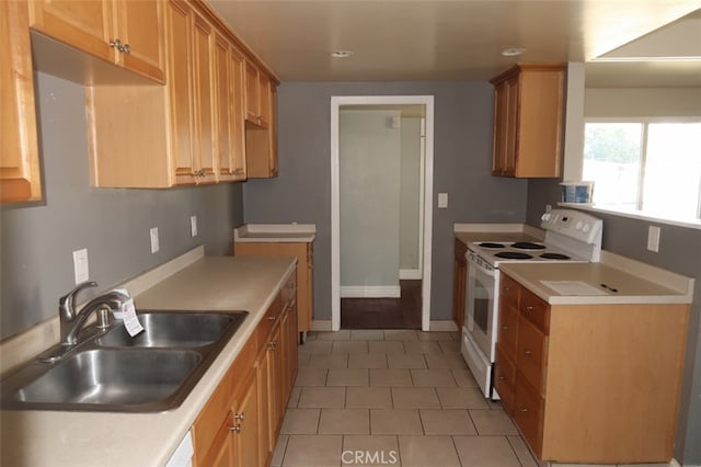 kitchen featuring light tile patterned flooring, sink, and white electric stove