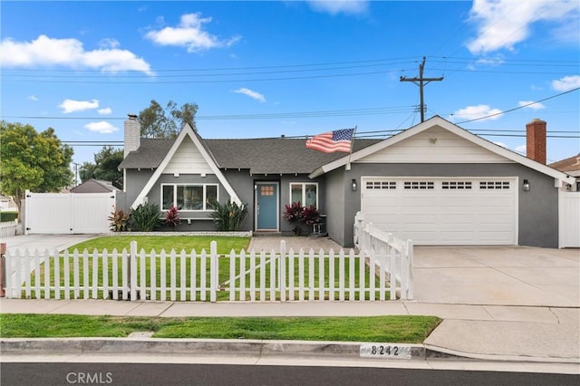 view of front of home with a front yard and a garage