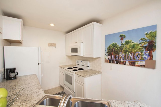 kitchen with decorative backsplash, white appliances, sink, and white cabinets