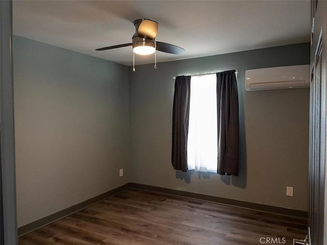 spare room with ceiling fan, dark hardwood / wood-style flooring, and an AC wall unit