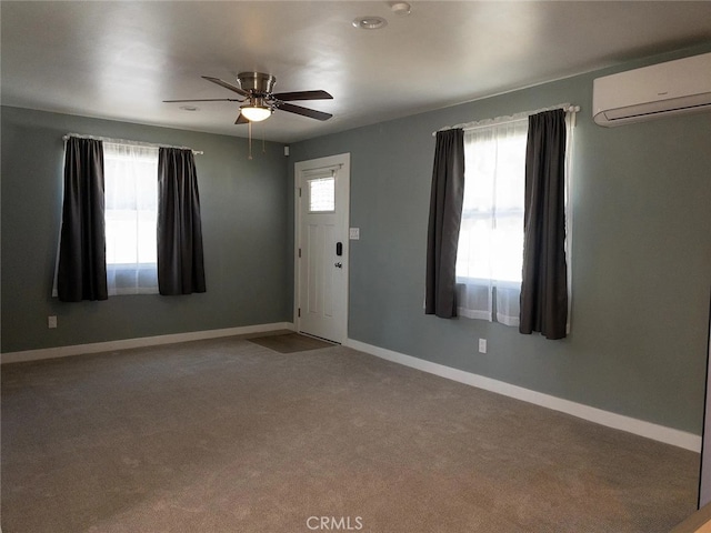 entryway with plenty of natural light, a wall mounted AC, and ceiling fan