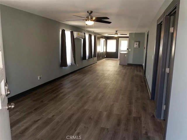 unfurnished room with ceiling fan, a wall mounted AC, and dark hardwood / wood-style floors