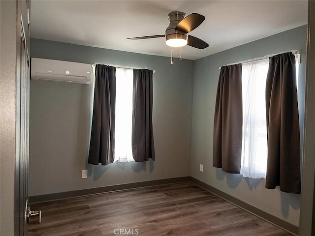 unfurnished room featuring ceiling fan, dark wood-type flooring, and an AC wall unit