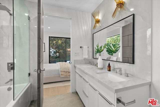 bathroom featuring vanity and combined bath / shower with glass door