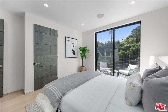 bedroom with access to outside and light hardwood / wood-style floors